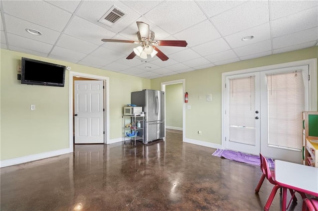 living room with concrete flooring, a ceiling fan, visible vents, french doors, and baseboards