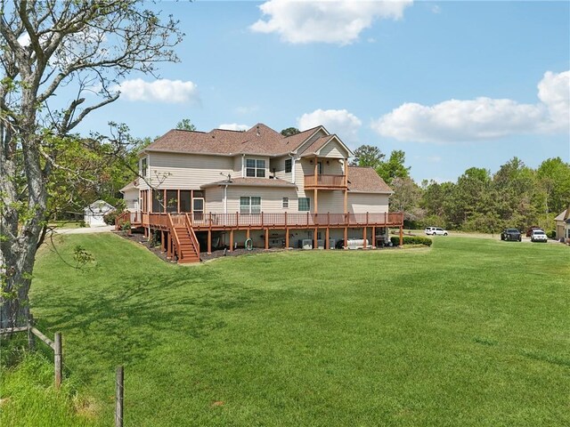 back of property featuring a yard, a deck, and stairway