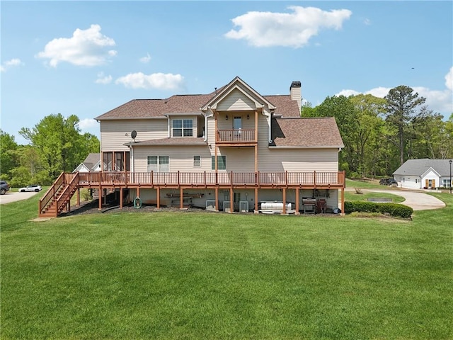 back of house with a balcony, a chimney, a shingled roof, and a lawn
