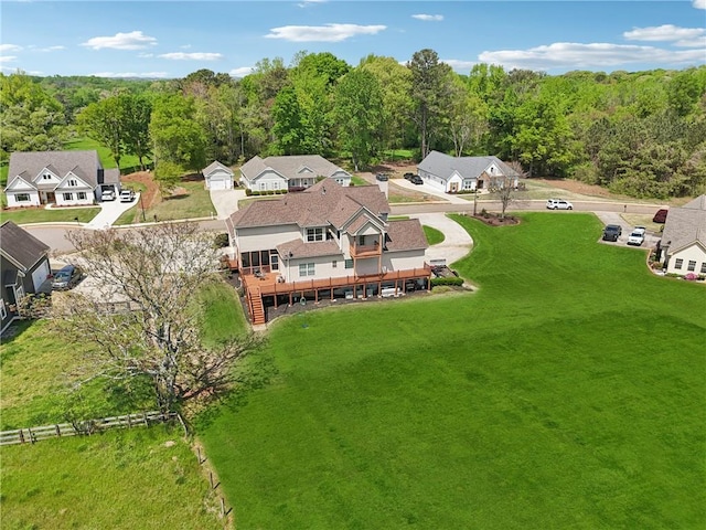 drone / aerial view featuring a forest view and a residential view
