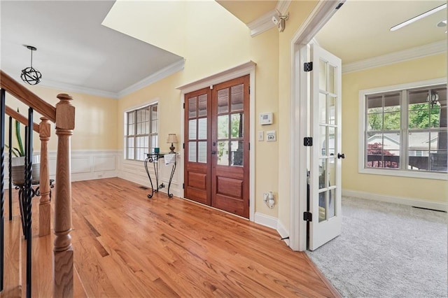 entryway featuring crown molding, french doors, and a wealth of natural light