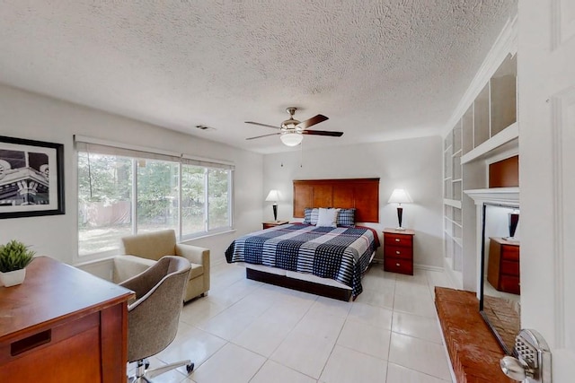 bedroom featuring a ceiling fan, visible vents, a textured ceiling, and light tile patterned flooring