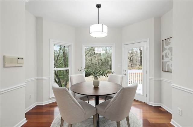 dining area featuring baseboards and wood finished floors