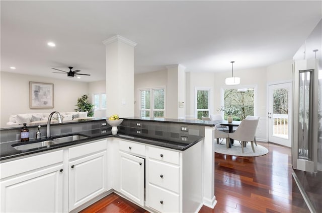 kitchen featuring pendant lighting, dark wood-style flooring, recessed lighting, white cabinetry, and a sink