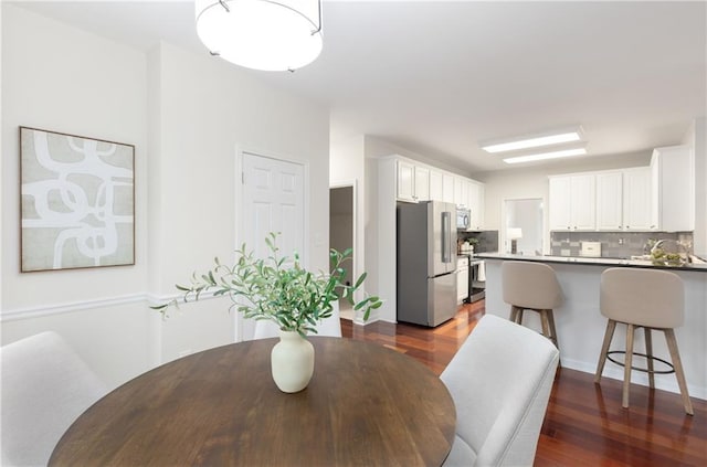 dining space featuring dark wood finished floors