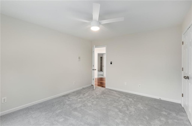 unfurnished bedroom with a ceiling fan, carpet flooring, and baseboards