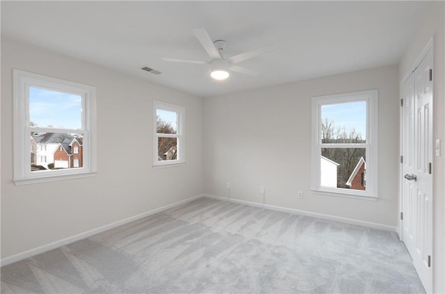 unfurnished bedroom with light colored carpet and multiple windows