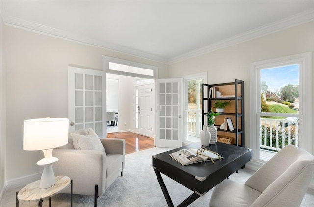 sitting room featuring light wood-type flooring, baseboards, ornamental molding, and french doors