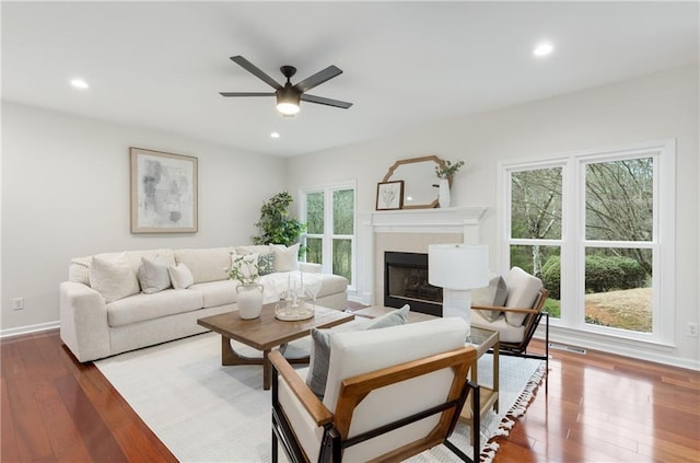 living area featuring recessed lighting, a fireplace, and hardwood / wood-style floors