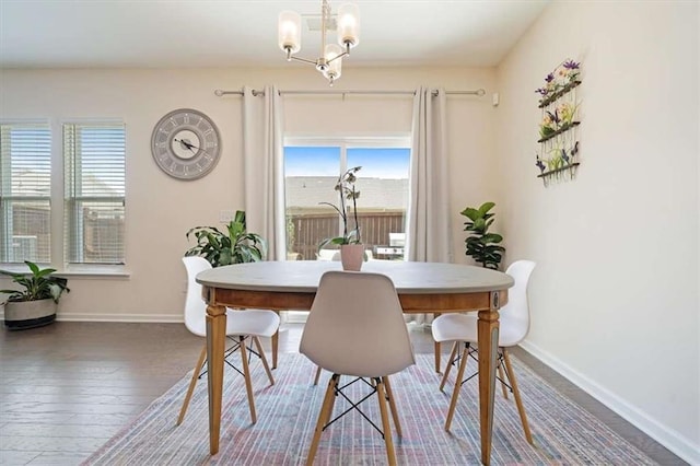 dining space featuring a notable chandelier and hardwood / wood-style flooring