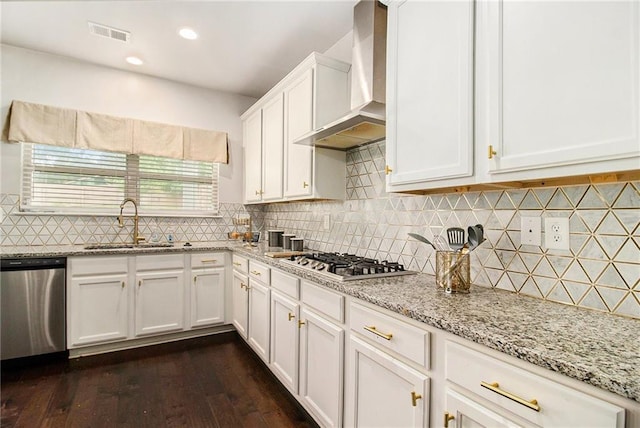 6213 Old Kingston Dr, Atlanta, GA 30331 - kitchen with wall chimney range hood, appliances with stainless steel finishes, white cabinets, dark wood-style floors, and light stone countertops