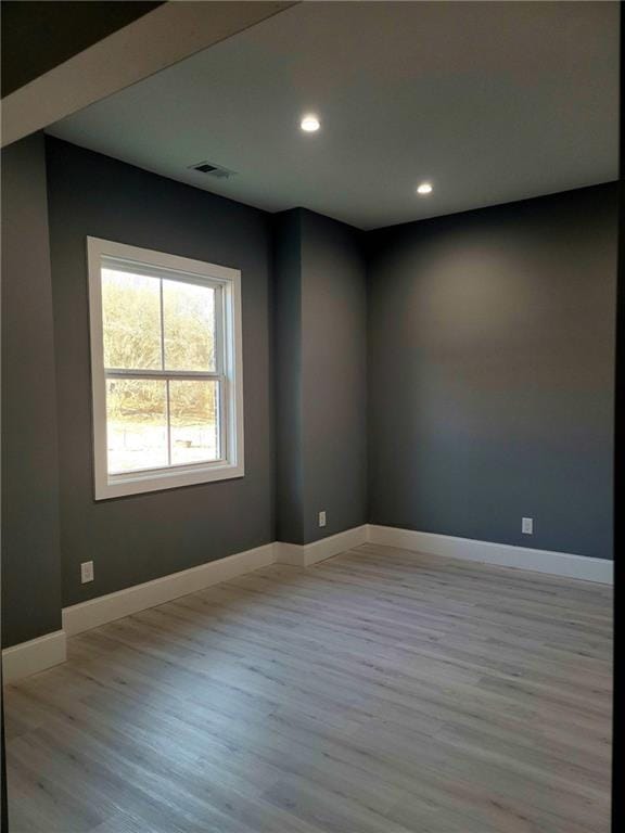 unfurnished room featuring light hardwood / wood-style floors