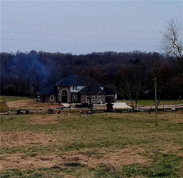 exterior space featuring a front lawn and a rural view