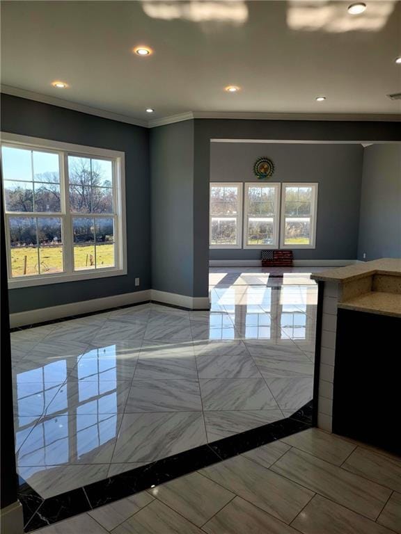 interior space with light tile patterned flooring and ornamental molding