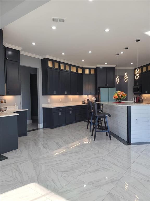 kitchen with fridge, hanging light fixtures, light tile patterned floors, and ornamental molding