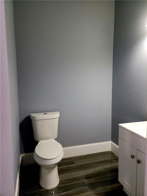 bathroom with vanity, wood-type flooring, and toilet