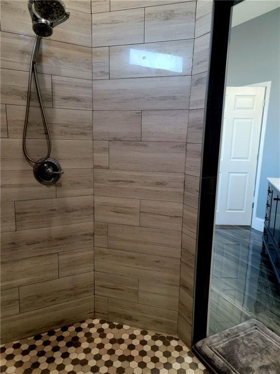 bathroom featuring vanity and a tile shower