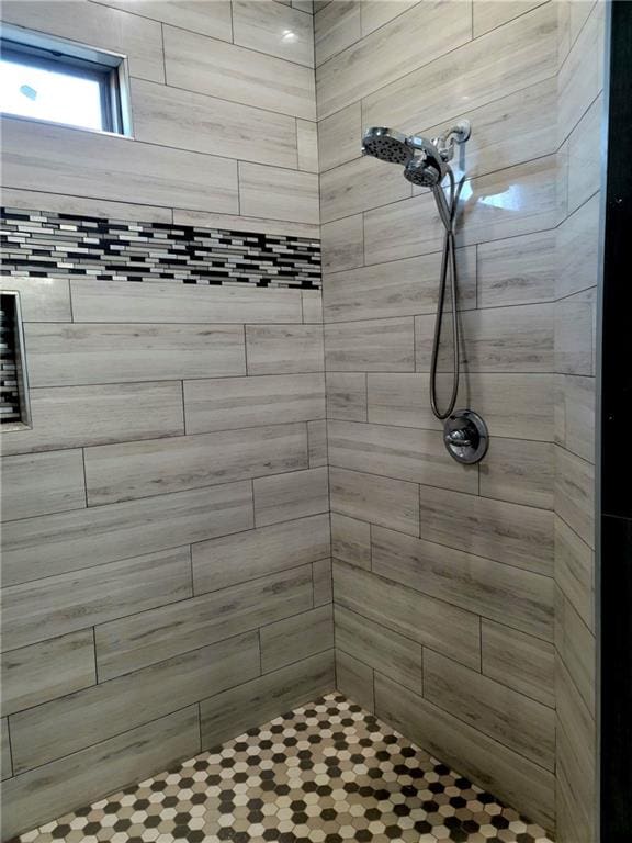 bathroom with a tile shower