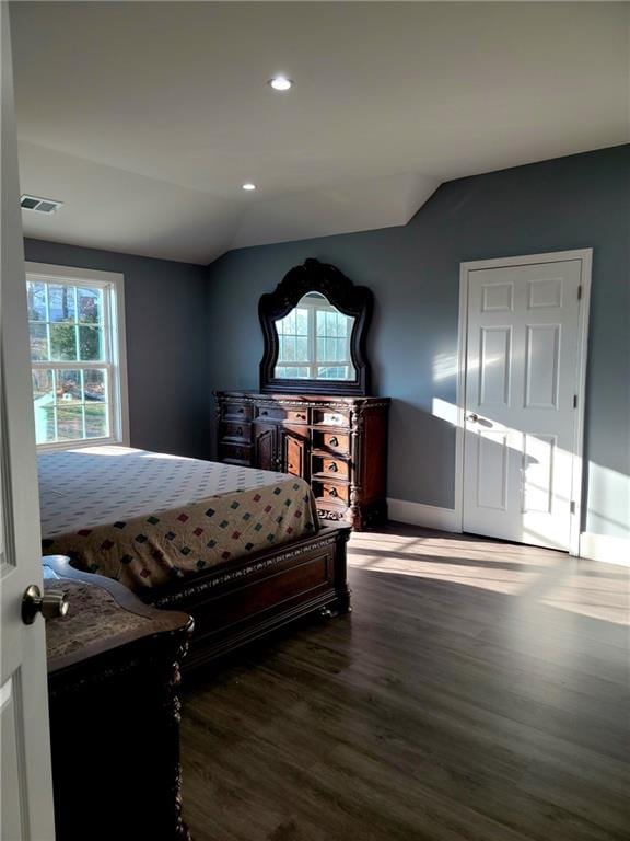 bedroom with wood-type flooring and lofted ceiling