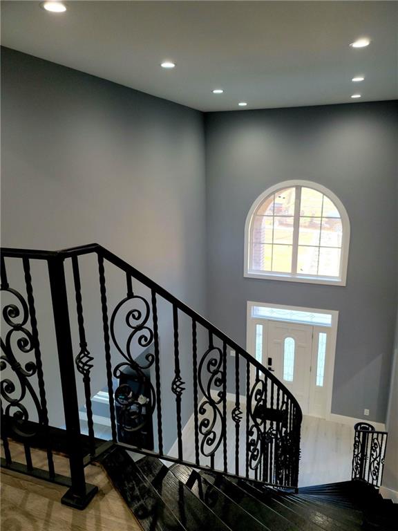 stairs with hardwood / wood-style flooring