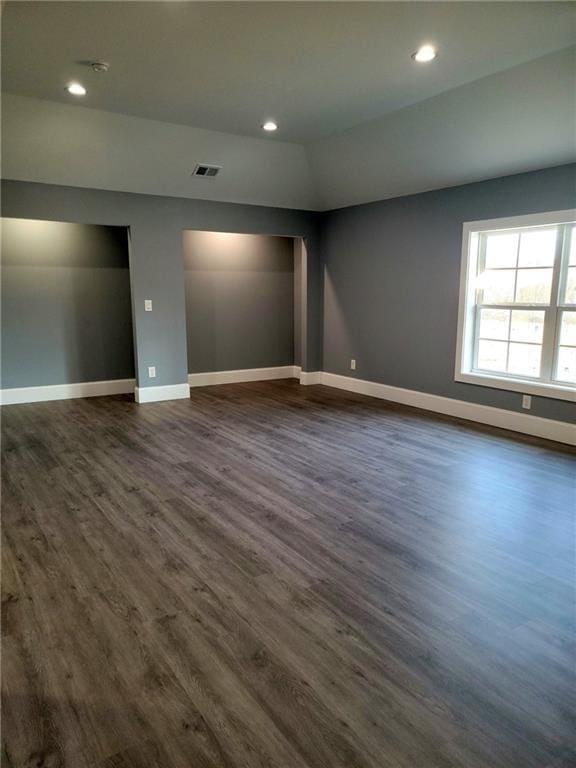 unfurnished room with dark wood-type flooring