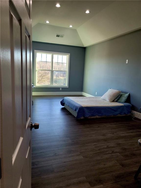 bedroom with dark hardwood / wood-style flooring and vaulted ceiling