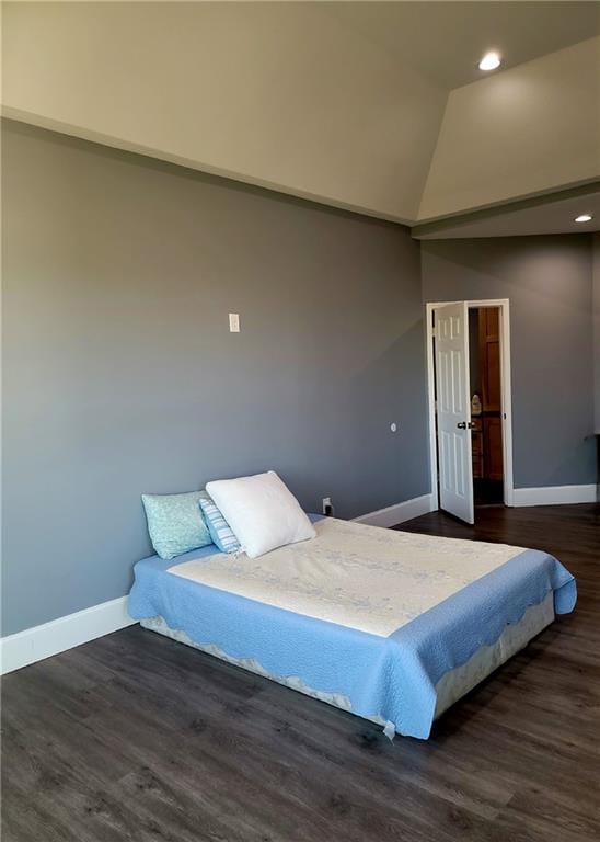 bedroom featuring dark hardwood / wood-style floors and lofted ceiling