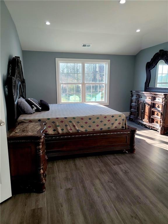 bedroom with wood-type flooring and vaulted ceiling