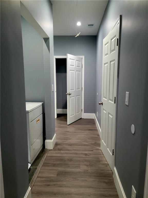 hall featuring washer / dryer and hardwood / wood-style floors