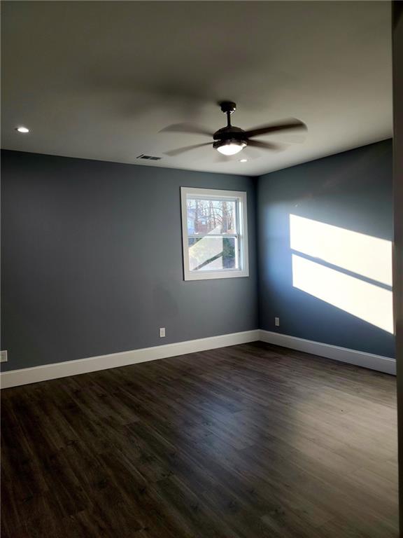 spare room featuring ceiling fan and hardwood / wood-style floors