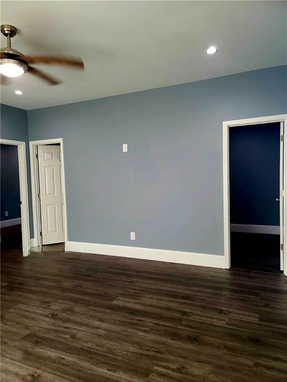 spare room featuring ceiling fan and dark hardwood / wood-style floors