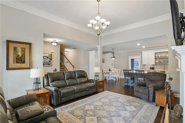 living room with dark wood-style flooring, baseboards, stairs, ornamental molding, and ornate columns