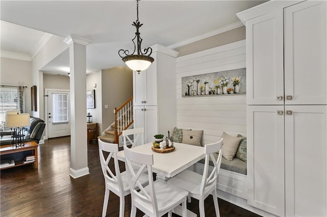 dining space with dark wood-style flooring, baseboards, ornamental molding, stairway, and ornate columns