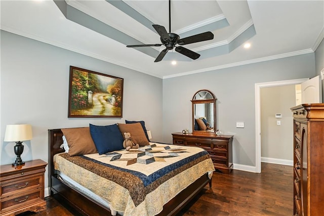 bedroom featuring a tray ceiling, dark wood-style flooring, crown molding, and baseboards