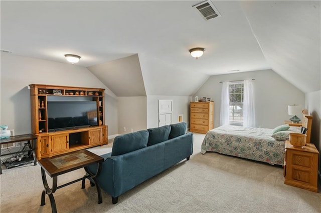 bedroom featuring carpet, visible vents, and vaulted ceiling