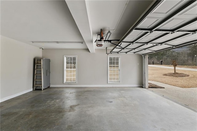 garage featuring baseboards and a garage door opener