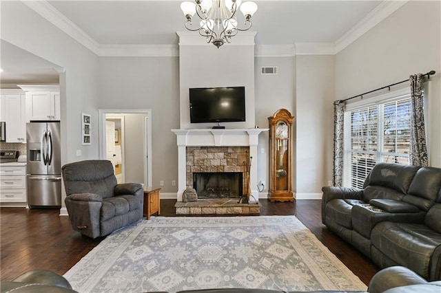 living room with ornamental molding, a stone fireplace, dark wood-type flooring, and visible vents