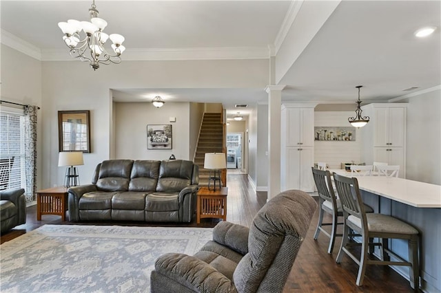 living area featuring dark wood finished floors, ornate columns, stairway, ornamental molding, and baseboards