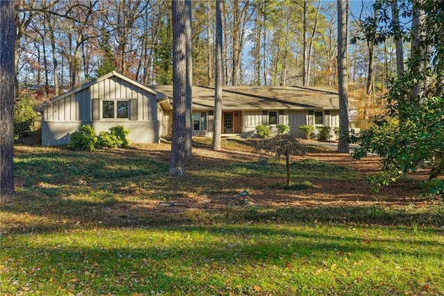 view of front of house with a front yard and board and batten siding