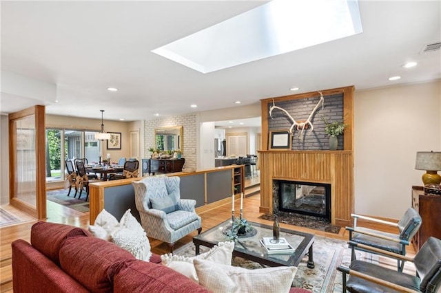 1959 Grand Prix Dr NE, Atlanta, GA 30345 - living room featuring wood finished floors, a skylight, a fireplace, recessed lighting, and baseboards