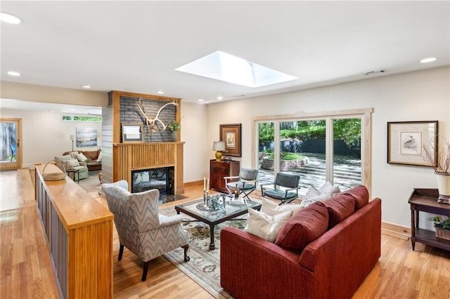 1959 Grand Prix Dr NE, Atlanta, GA 30345 - living area featuring a skylight, a large fireplace, light wood-style floors, recessed lighting, and baseboards