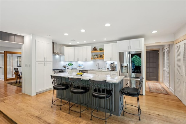 1959 Grand Prix Dr NE, Atlanta, GA 30345 - kitchen featuring stainless steel refrigerator with ice dispenser, wall chimney range hood, a sink, a breakfast bar, and white cabinets