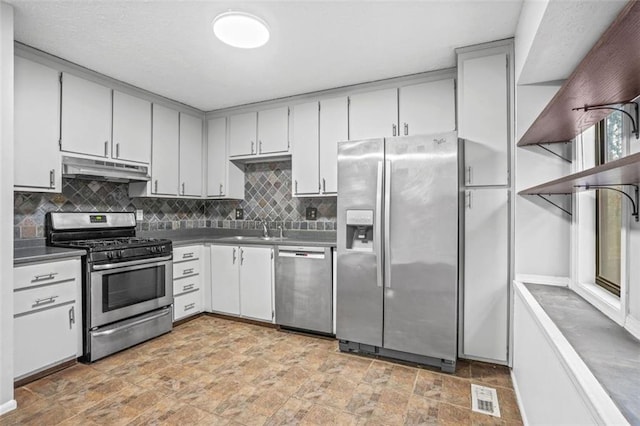 kitchen with sink, decorative backsplash, and stainless steel appliances