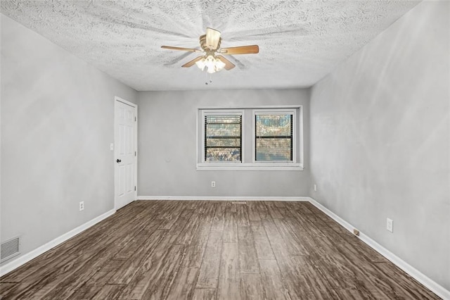 unfurnished room with a textured ceiling, dark hardwood / wood-style floors, and ceiling fan