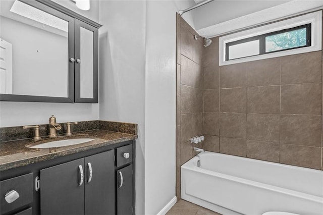 bathroom featuring tile patterned floors, vanity, and tiled shower / bath combo