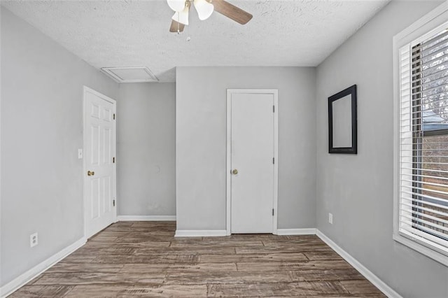 spare room featuring ceiling fan, wood-type flooring, and a textured ceiling