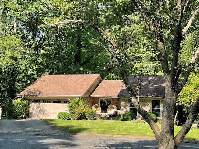 210 N Trce, Alpharetta, GA 30009 - view of front of home with asphalt driveway, an attached garage, a front yard, a shingled roof, and brick siding
