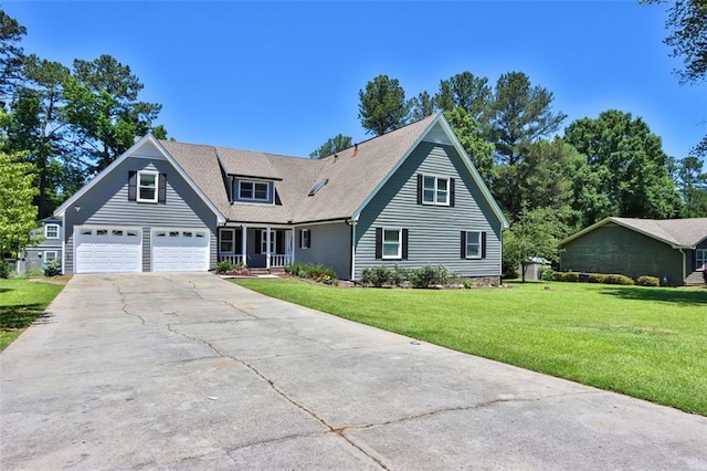 view of front of home featuring a front lawn, covered porch, and a garage