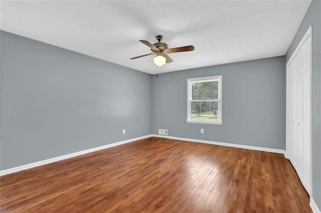 unfurnished room featuring ceiling fan and hardwood / wood-style floors