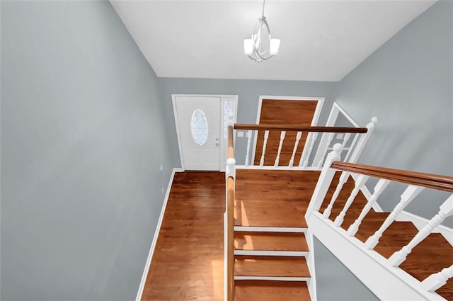 foyer entrance featuring hardwood / wood-style floors and an inviting chandelier